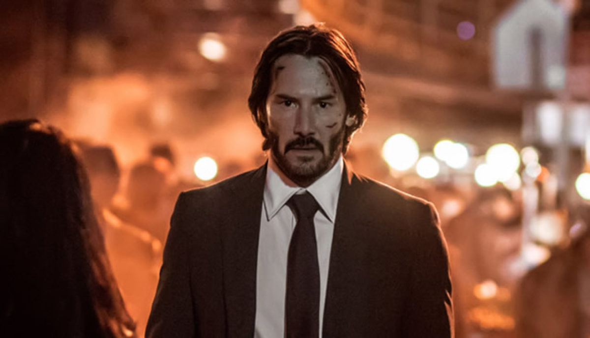 The movie John Wick 2. John wears a dirty white shirt. This is because all his clothes and his washer were burned up when they blew up his house. His dog is