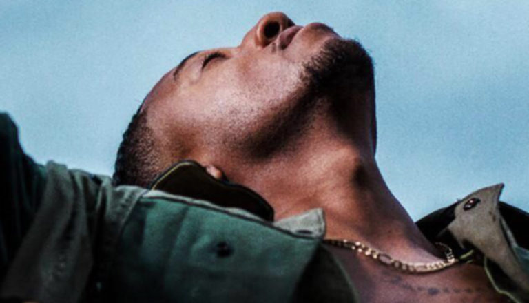 Christian rapper Lecrae's latest album shows him lifting arms up and looking toward the sky in a prayerlike pose.