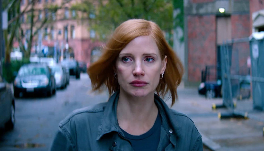 A nervous woman (Jessica Chastain) walks down the street, casting a subtle glance behind her.