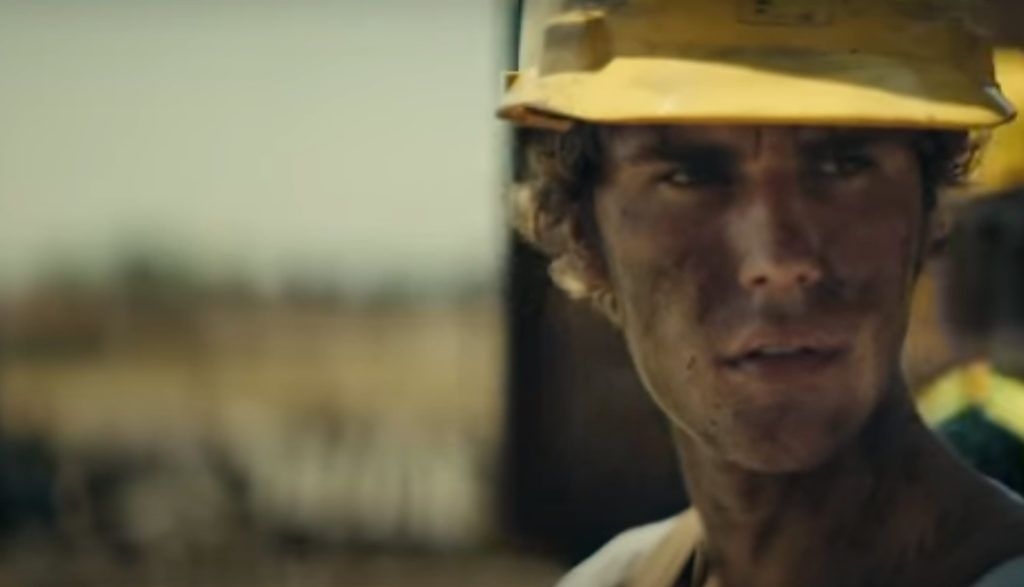 Justin BIeber plays the role of an oil work and is dirty out on the oilfield.