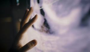 Picture of someone touching an ultrasound image tenderly.