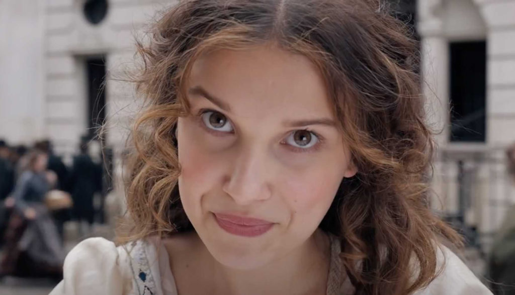 Enola Holmes (actress Millie Bobbie Brown) making a face to the camera.