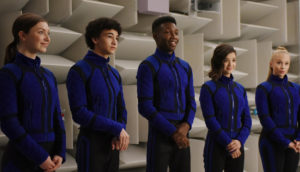Five super-powered teens line up in blue uniforms.