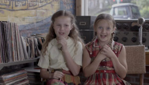 Two young girls laugh together.