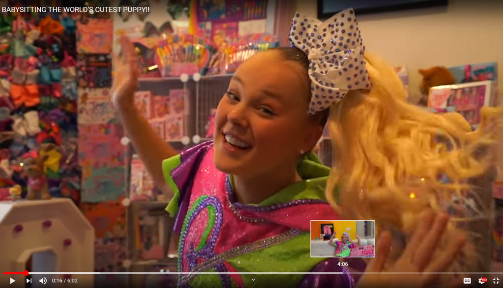 Screen shot of smiling Jojo Siwa from her YouTube Channel