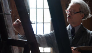 We see at man at an easel painting.