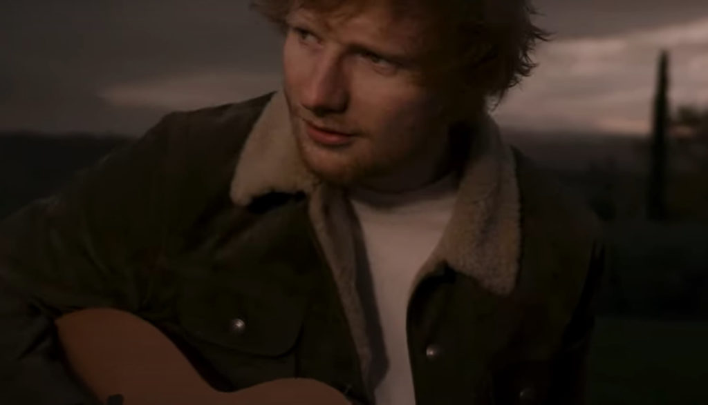 Singer-songwriter Ed Sheeran plays guitar in the video for the song "Afterglow."
