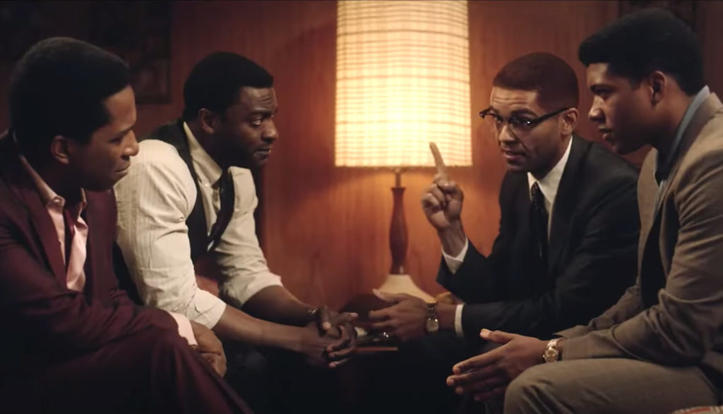 Malcolm X, Cassius Clay, Jim Brown and Sam Cooke talk in a hotel in the movie One Night in Miami.