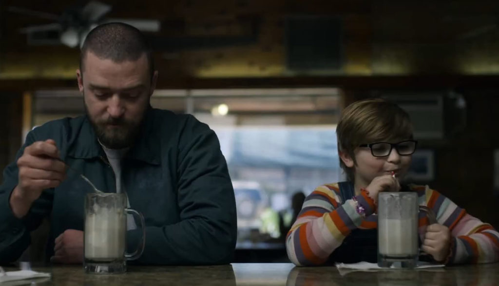 A man and a boy eat at a diner.