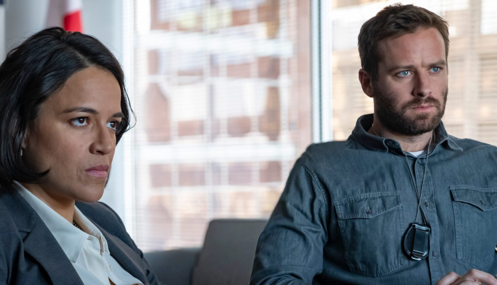 A man and a woman sit in an office.