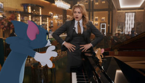 Animated Tom and Jerry talk to a real-life hotel worker.