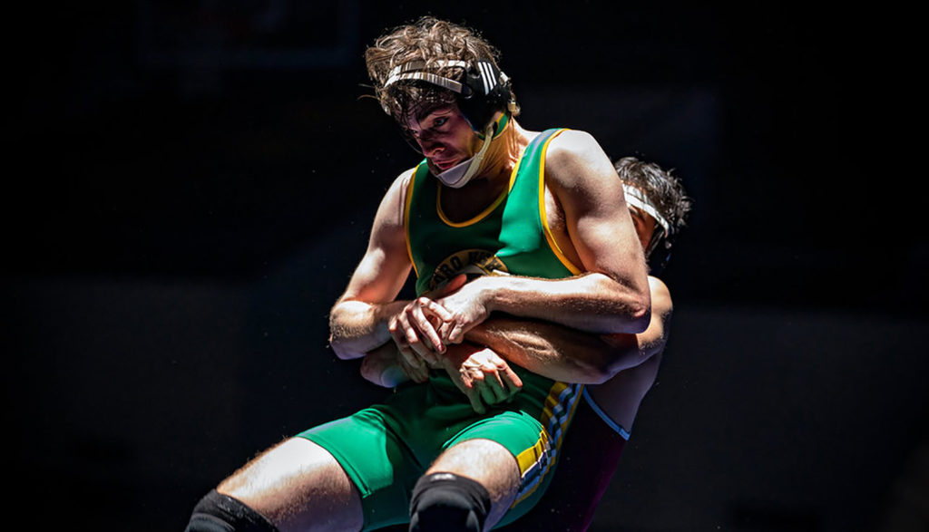 We see an image of two young men wrestling.