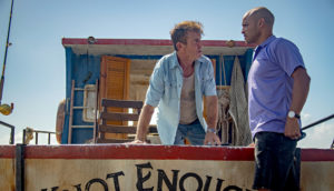 Two men on a boat in Blue Miracle