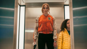 woman and girl on an elevator with a gun