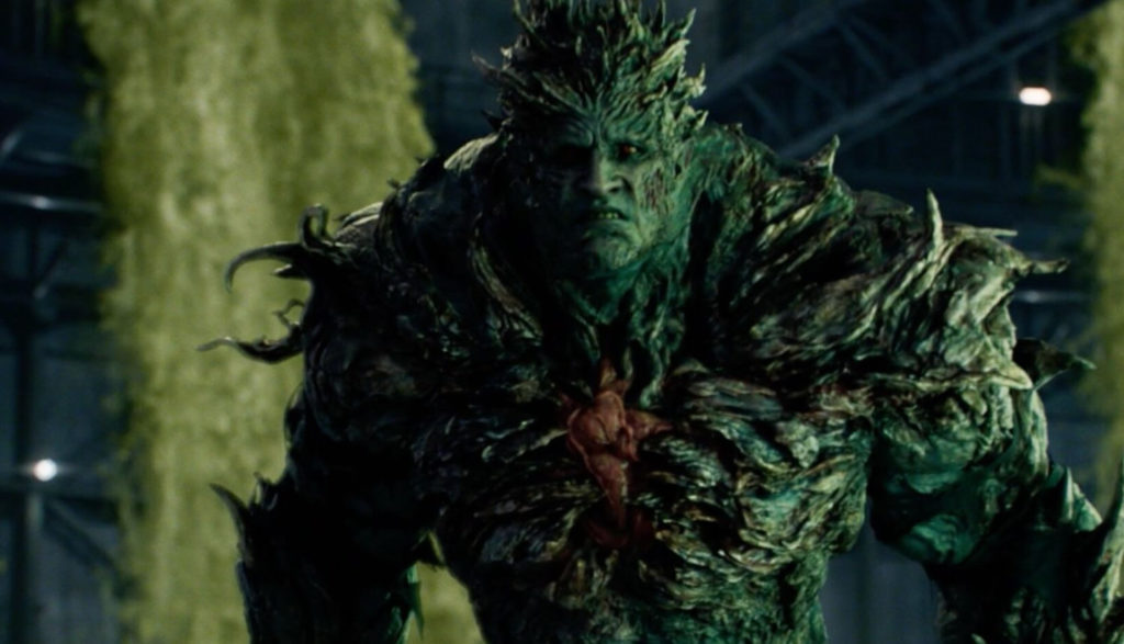An ugly green zombie shambles forward.