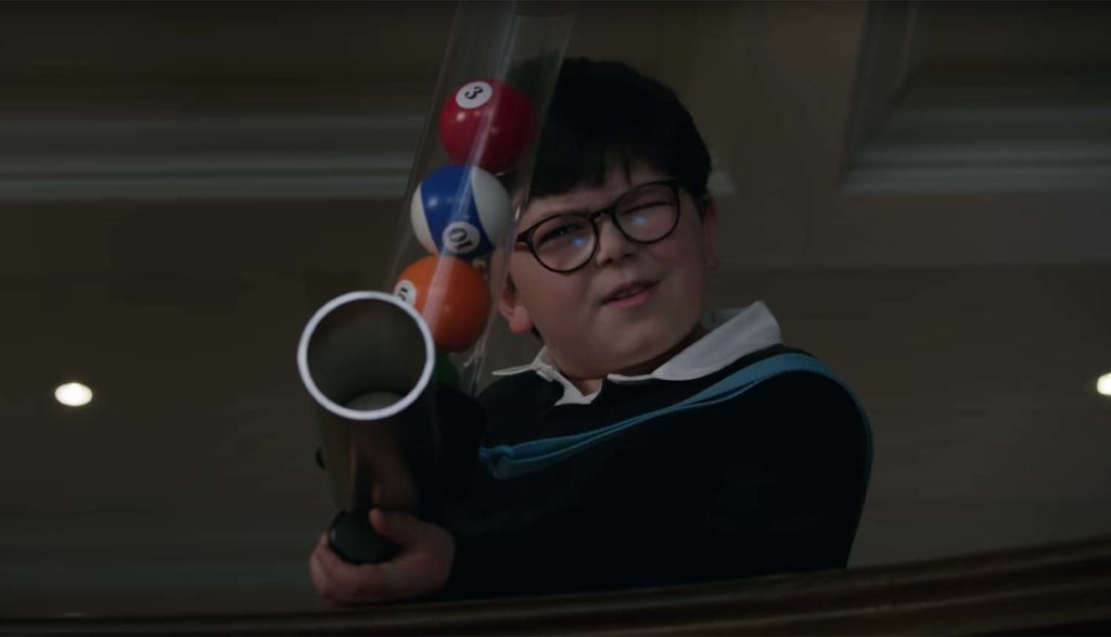Boy with t-shirt cannon loaded with billiard balls from Home Sweet Home Alone