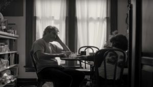 a man and boy sitting at a table in Cmon Cmon movie
