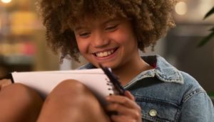 Little girl drawing on notepad - Amber Brown