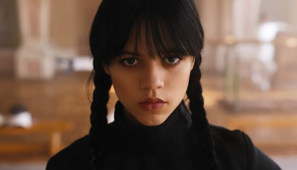 a girl with black braids in a black fencing uniform - Wednesday