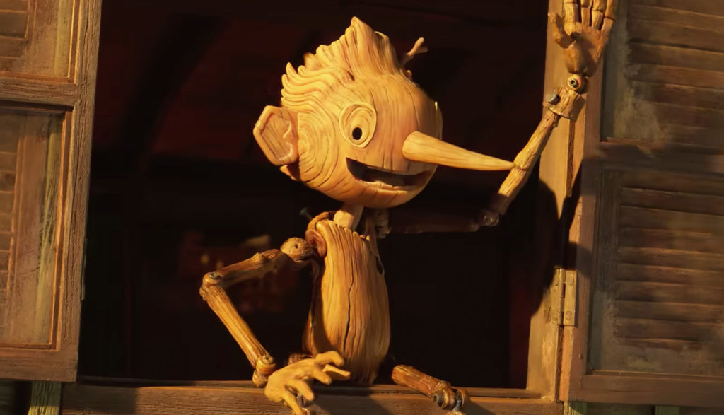 wooden puppet waving at fans - Guillermo del Toro's Pinocchio