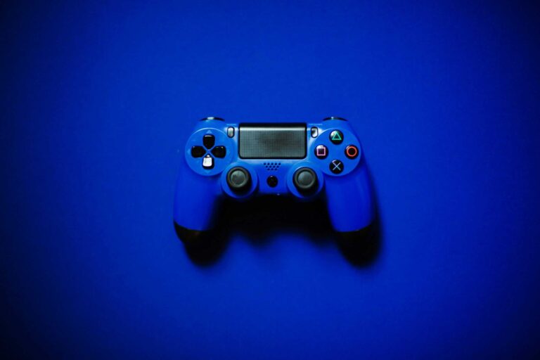 This image shows a blue controller in front of a blue background