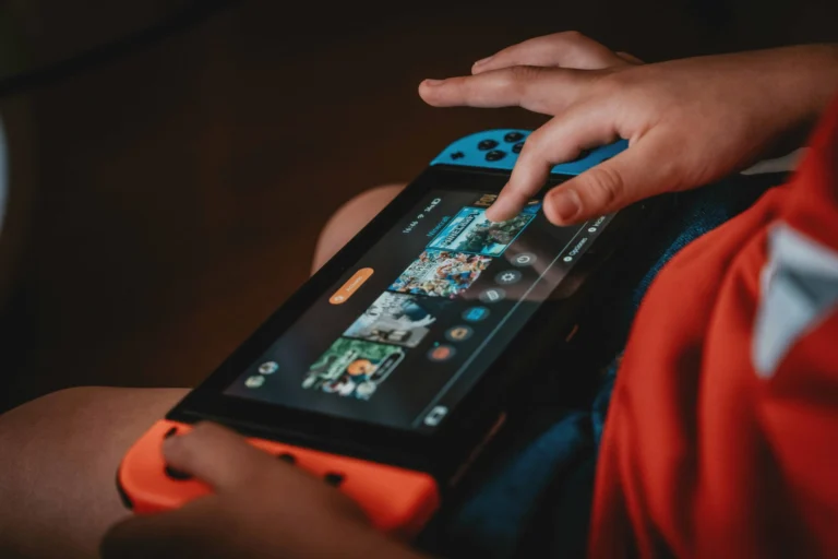 Close up of child's hands playing a video game controller